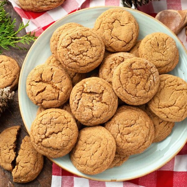 Several Soft Chewy Ginger Cookies on grey plate with red gingham napkin