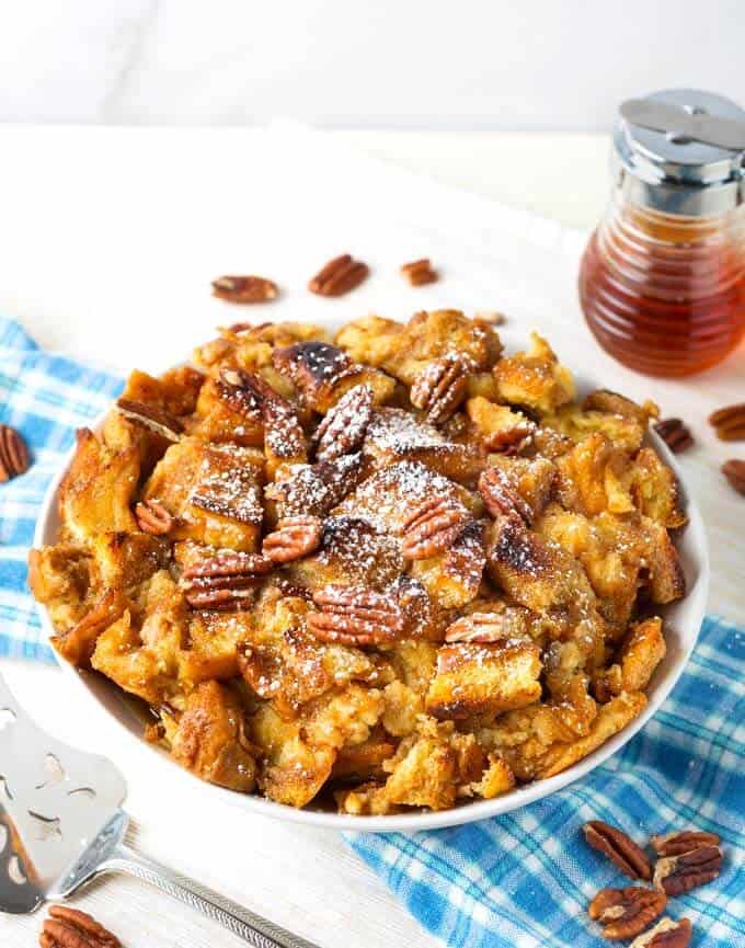 Pressure cooker French Toast Casserole in white bowl topped with pecans