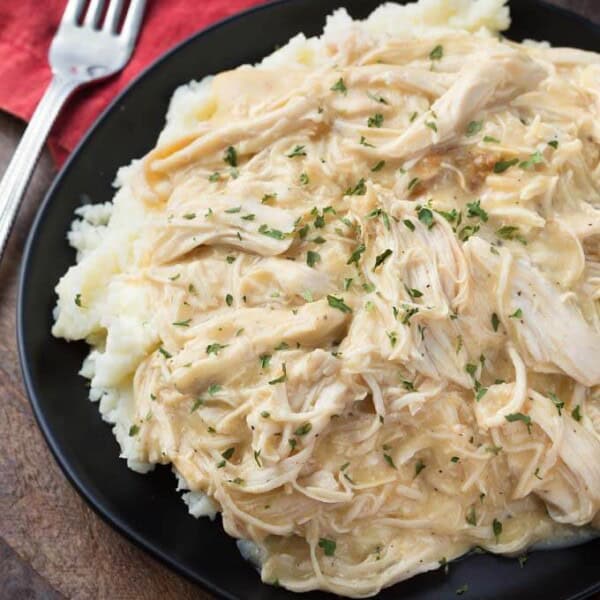 Slow Cooker Chicken and Gravy on black plate