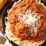 Slow Cooker Chicken Cacciatore over noodles on black plate