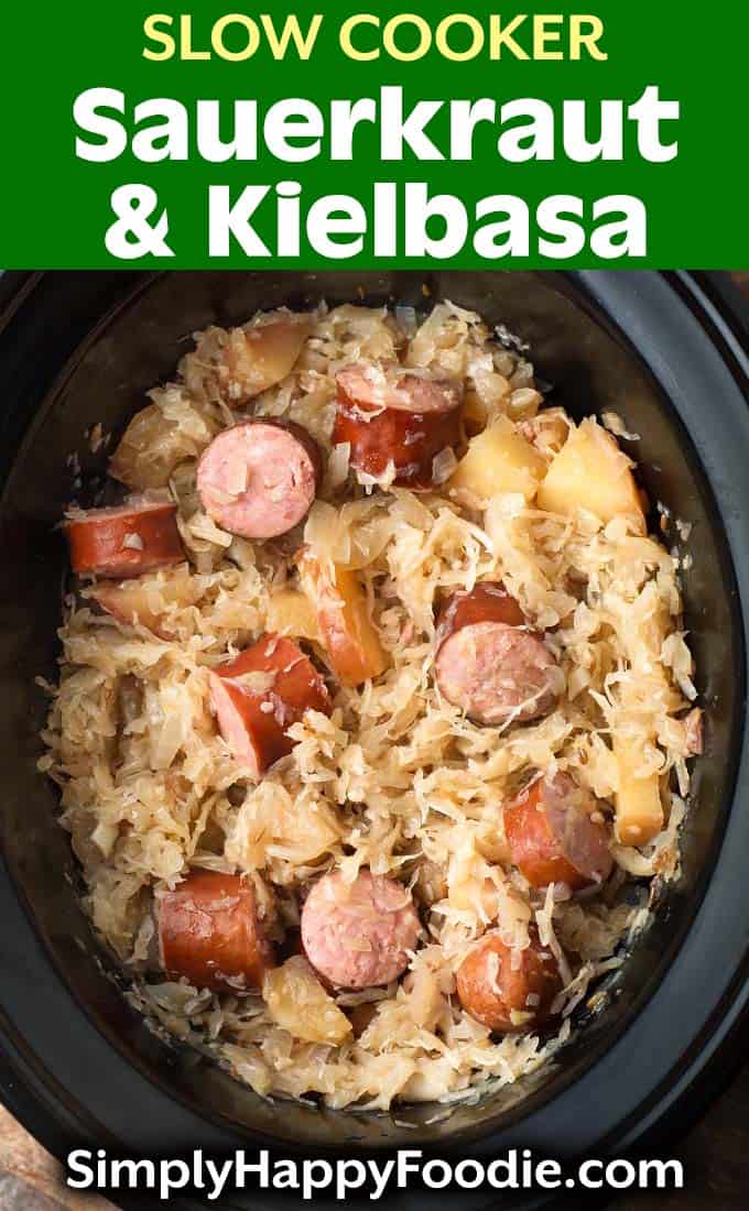Saurerkraut and Kielbasa in slow cooker with wooden spoon as well as title and Simply Happy Foodie.com logo