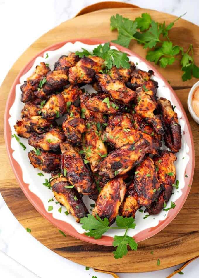 Air Fryer Chicken Wings on oval plate on wooden board