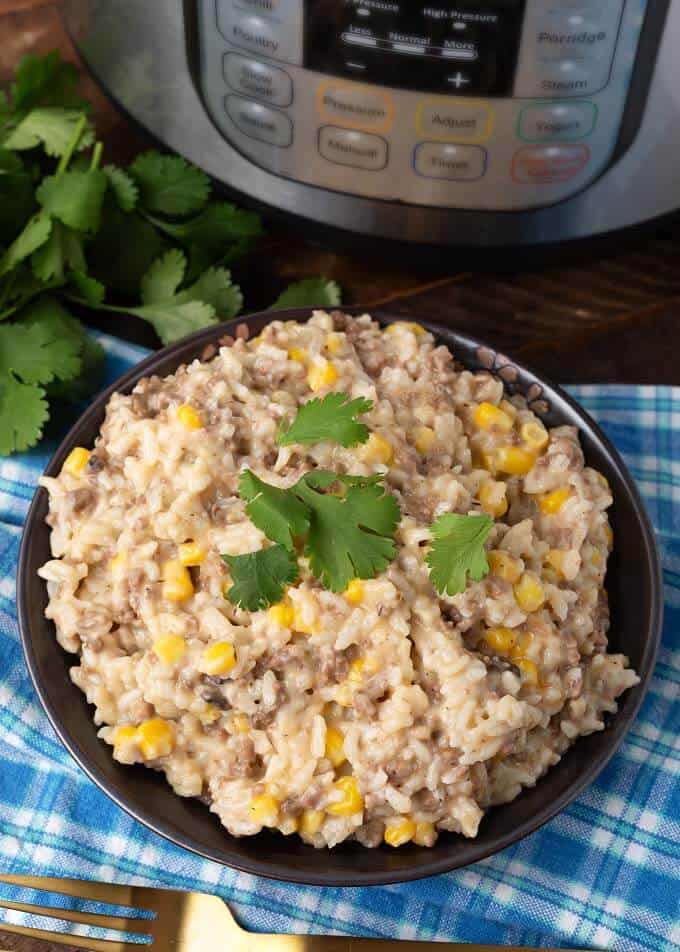 Pressure Cooker Cheesy Hamburger Rice Casserole on dark brown plate