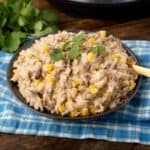 Instant Pot Cheesy Hamburger Rice Casserole on a dark brown plate with fork