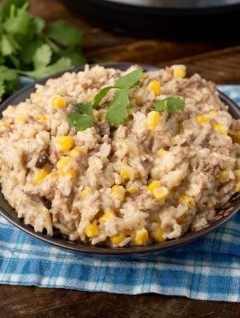 Instant Pot Cheesy Hamburger Rice Casserole on a dark brown plate with fork