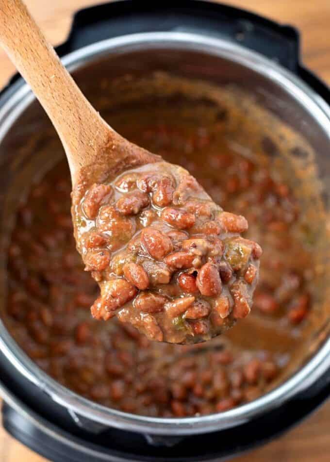 Close up of Instant Pot Mexican Pinto Beans on wooden serving spoon