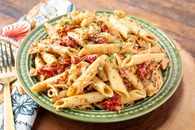 Pressure Cooker Pesto Pasta on green plate next to fork