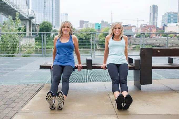 two women holding a workout pose