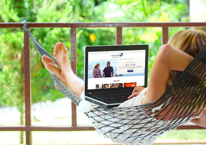 woman in hammock looking at laptop computer