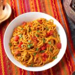 Instant Pot Taco Spaghetti in a white bowl on a red orange striped cloth