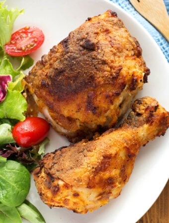 air fryer fried chicken on a white plate with salad