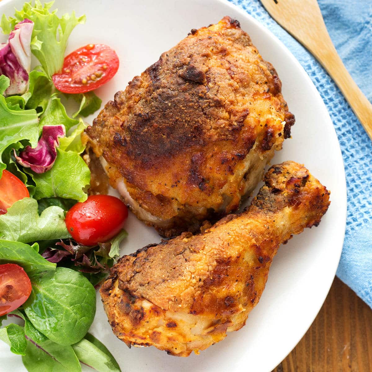 air fryer fried chicken on a white plate with salad