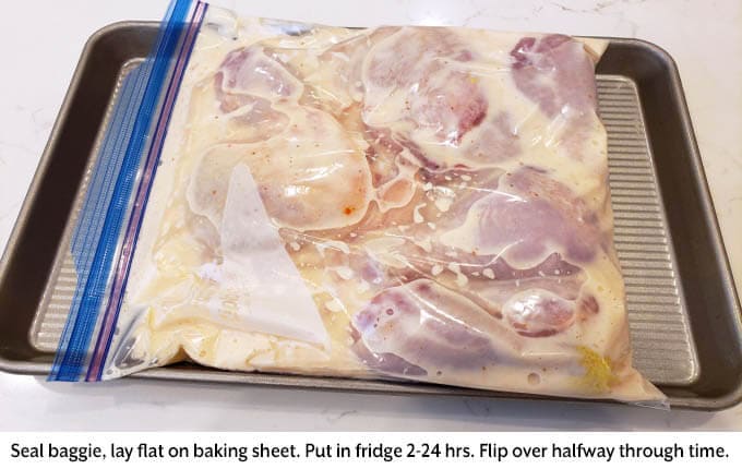 chicken in baggie on baking sheet