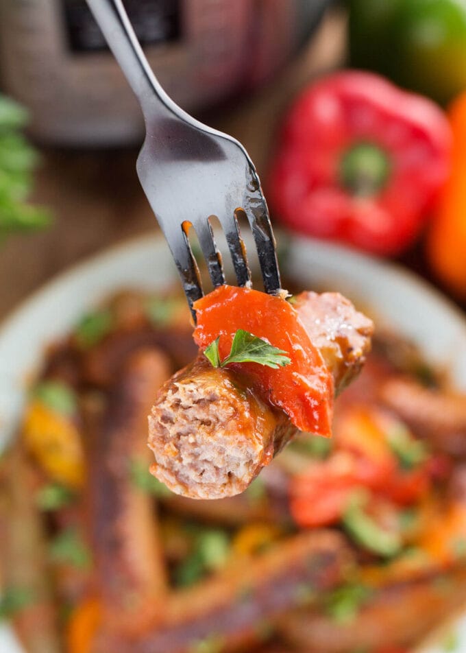 a half sausage on the end of a fork, close up