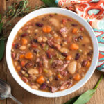 Instant Pot 15 Bean Soup in white bowl on wood