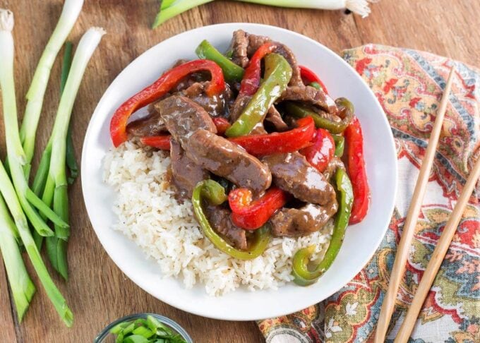 Instant Pot Pepper Steak on a white plate with wood background