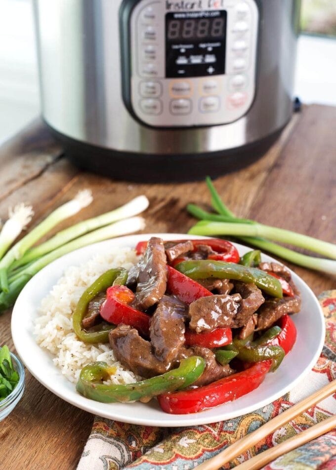 Instant Pot Pepper Steak on a white plate with IP in background