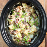 Slow Cooker Bacon Ranch Potatoes in a black crock