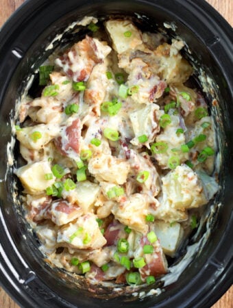 Slow Cooker Bacon Ranch Potatoes in a black crock