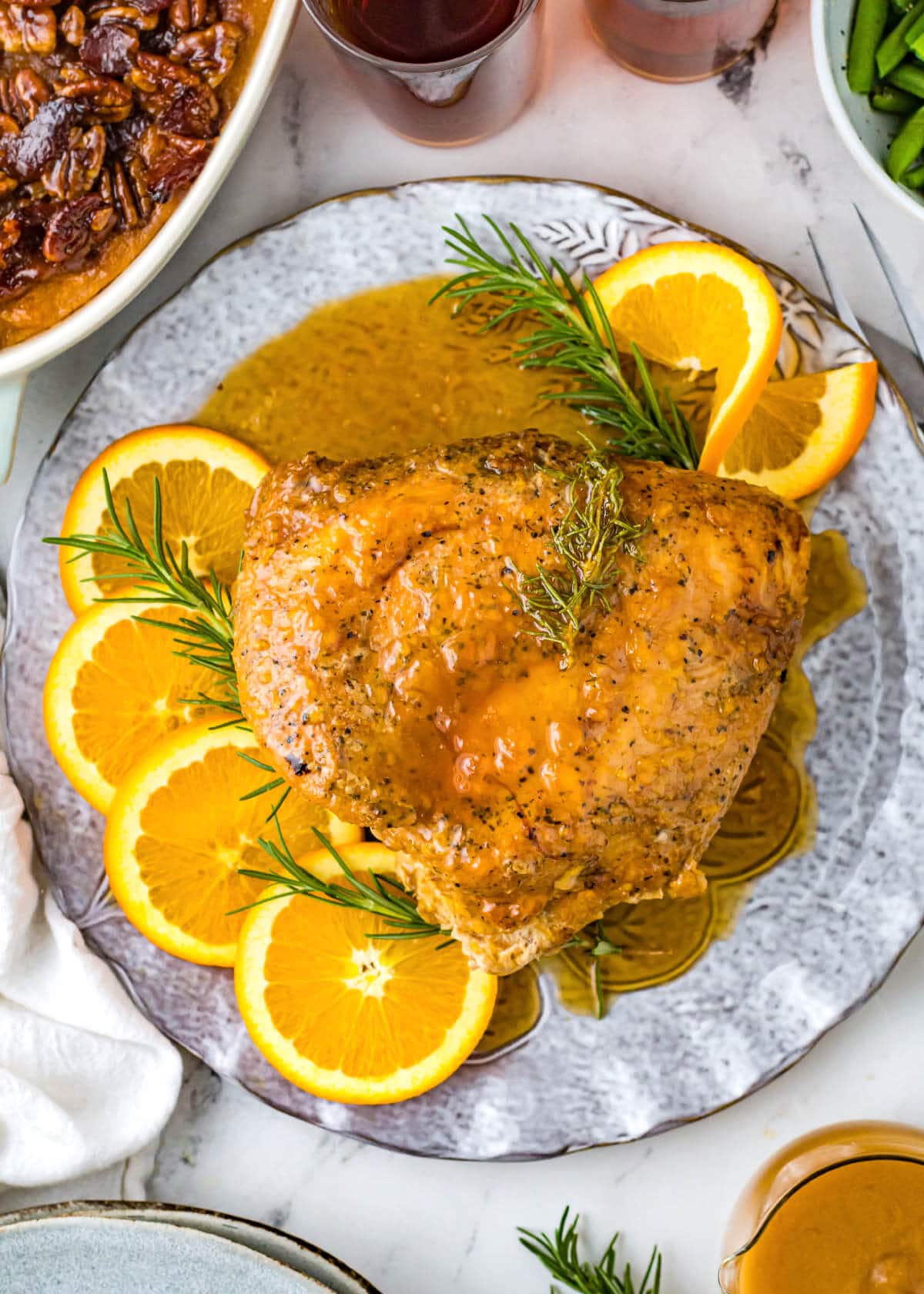 whole turkey breast portion on a plate with garnishes