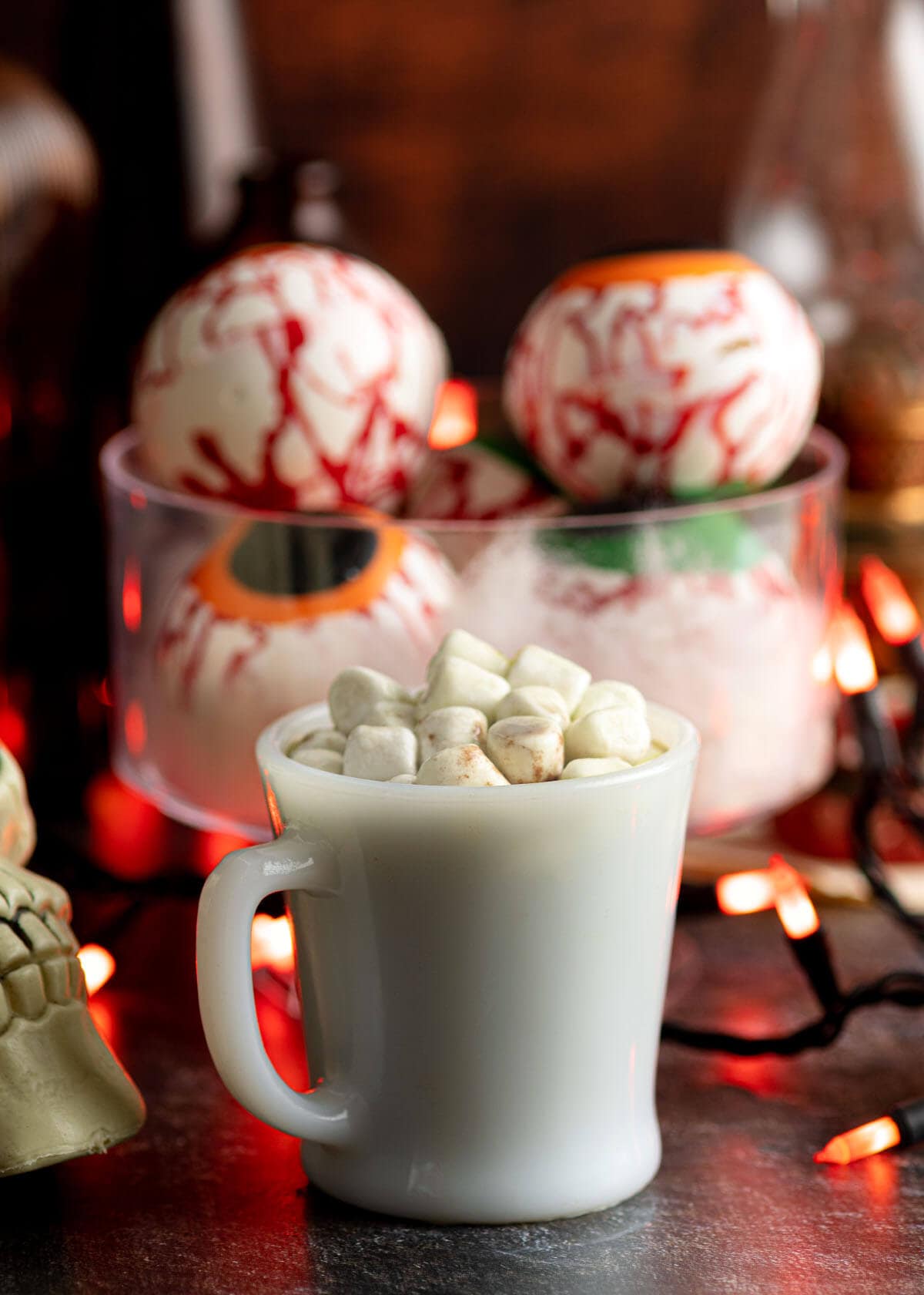 Halloween Eyeball Hot Cocoa Bombs and cup of cocoa with marshmallows