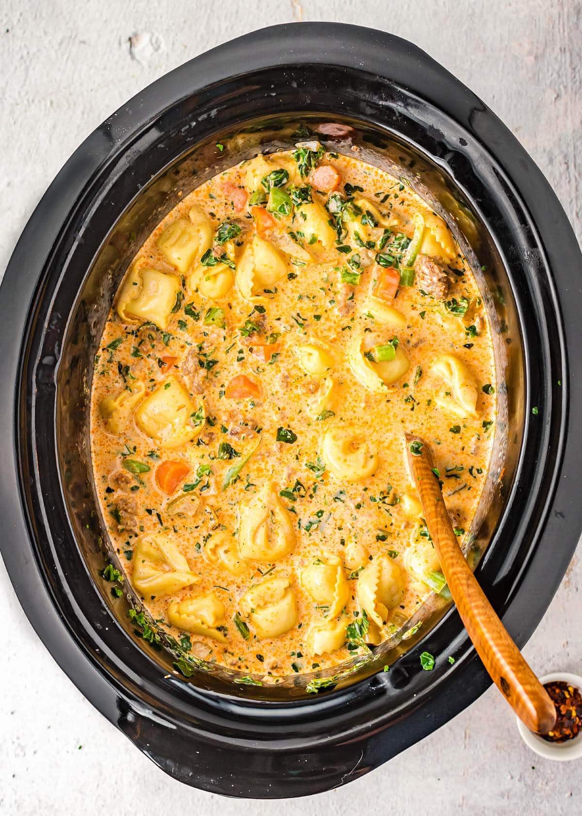 slow cooker creamy tortellini soup in black crock