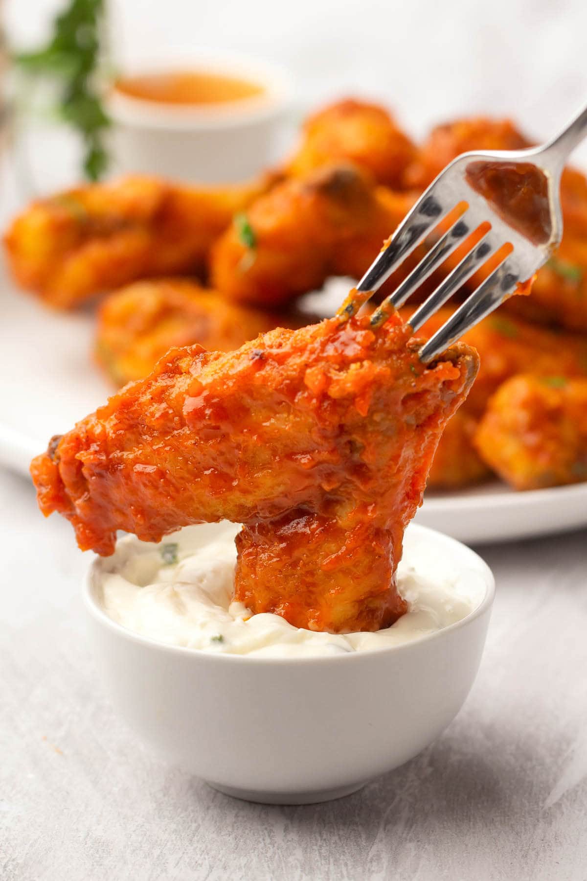 Air Fryer Buffalo Chicken Wing dipped in sauce