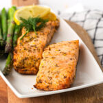 2 pieces Air Fryer Salmon on a white plate