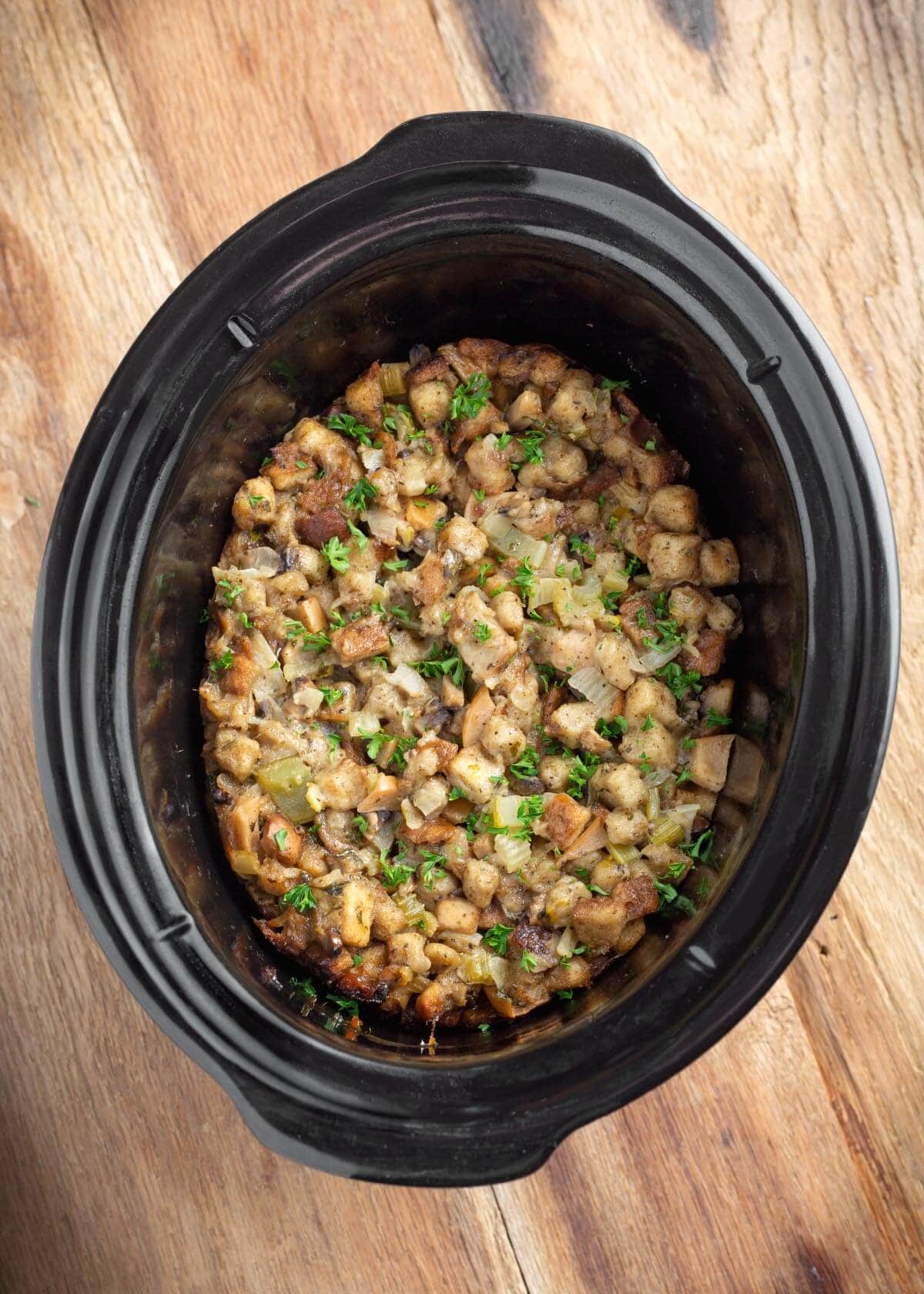 easy slow cooker stuffing cooked in a black crock