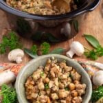 stuffing in a green bowl in front of crock