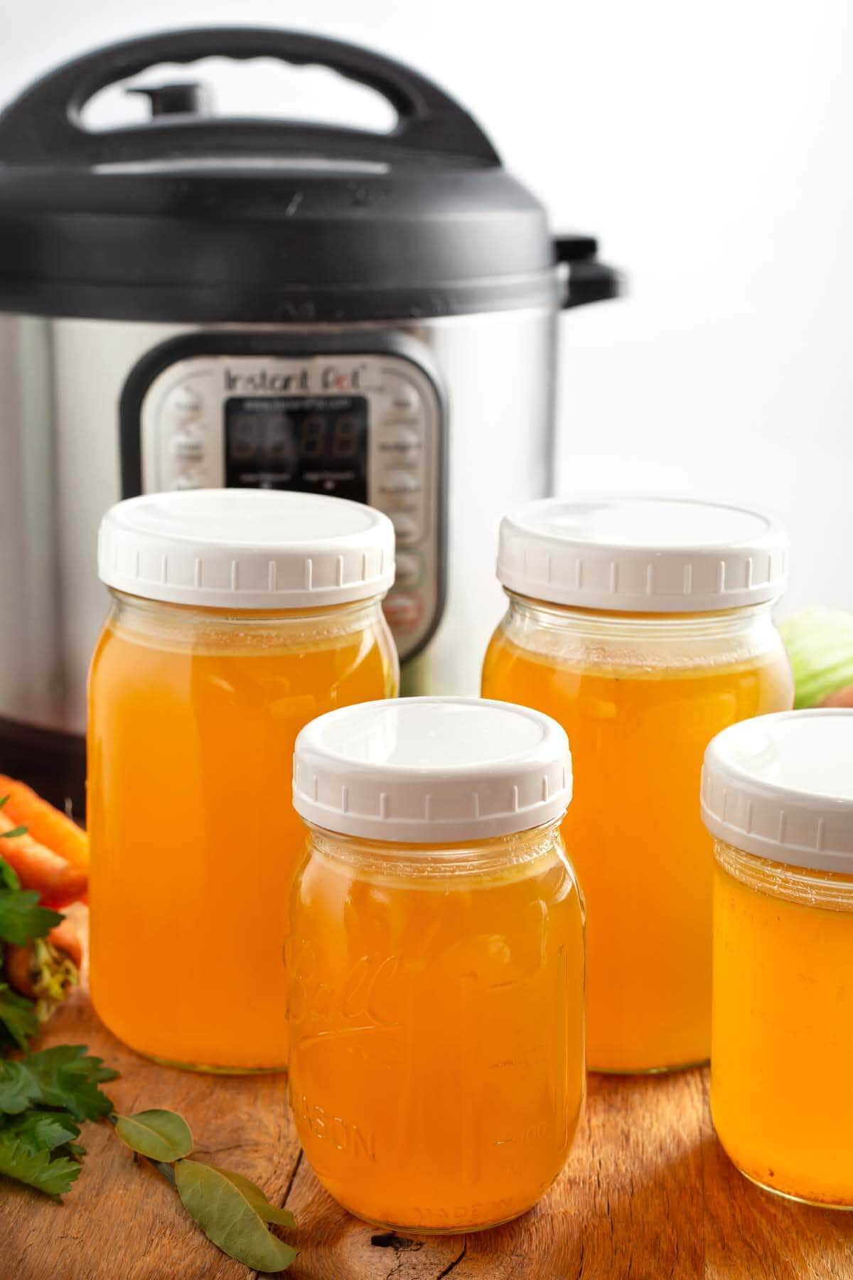 Instant Pot Turkey Broth in jars in front of IP