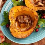 Slow Cooker Acorn Squash halves on a blue plate