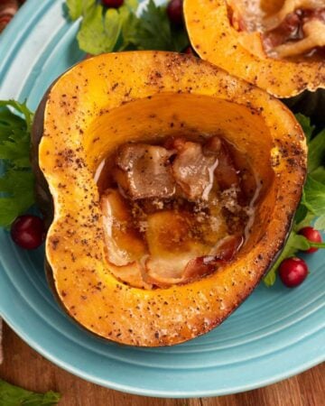 Slow Cooker Acorn Squash halves on a blue plate