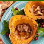 Slow Cooker Acorn Squash halves on a blue plate