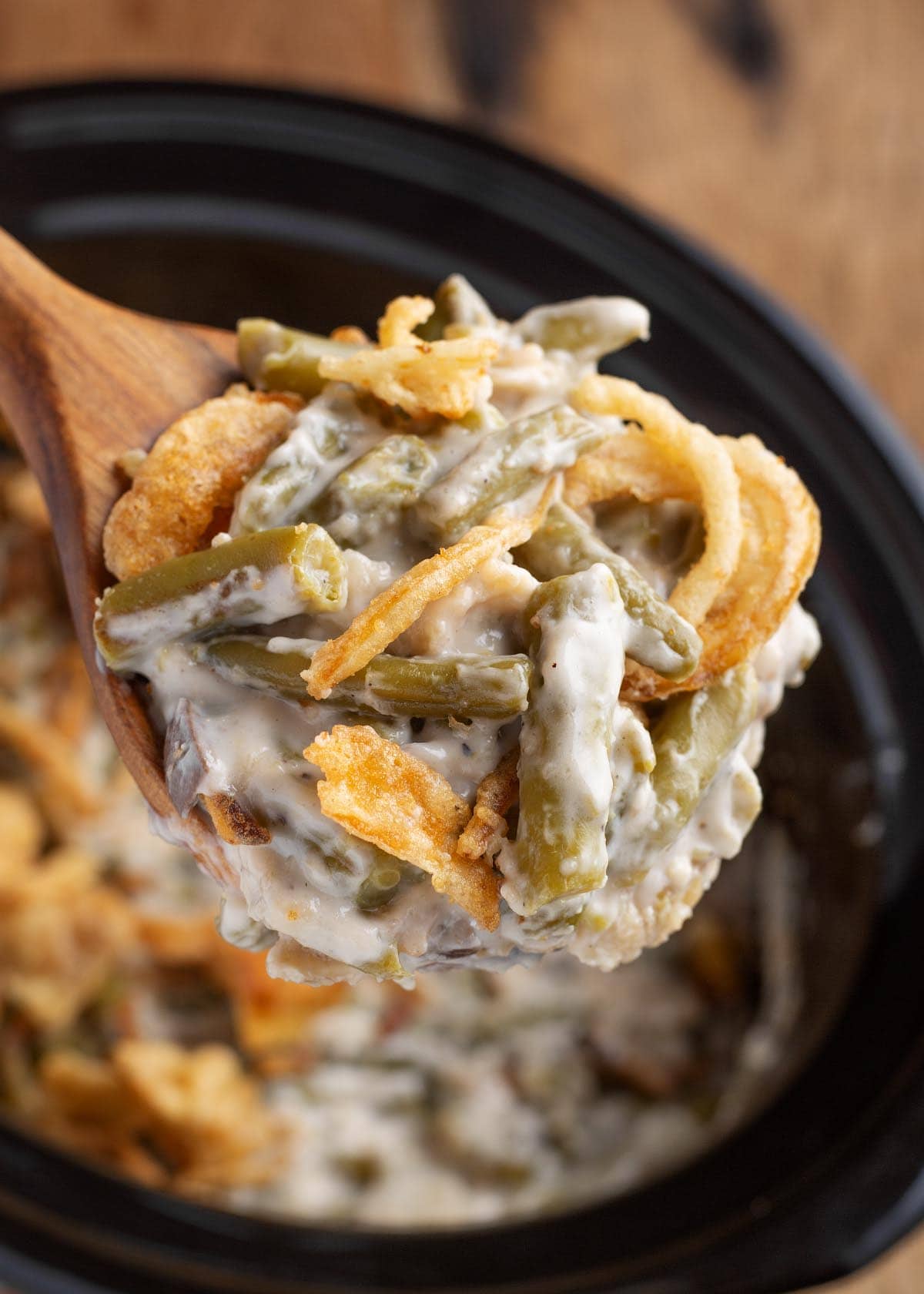 Green Bean Casserole on a wood spoon