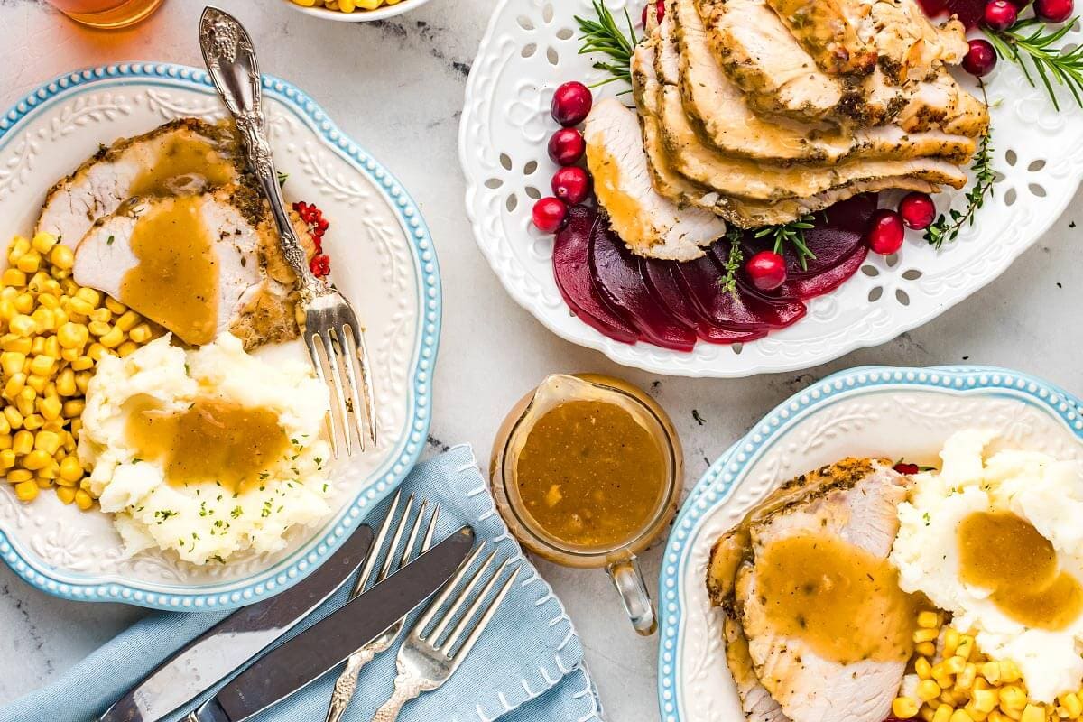 plates artfully arranged with turkey slices and side dishes