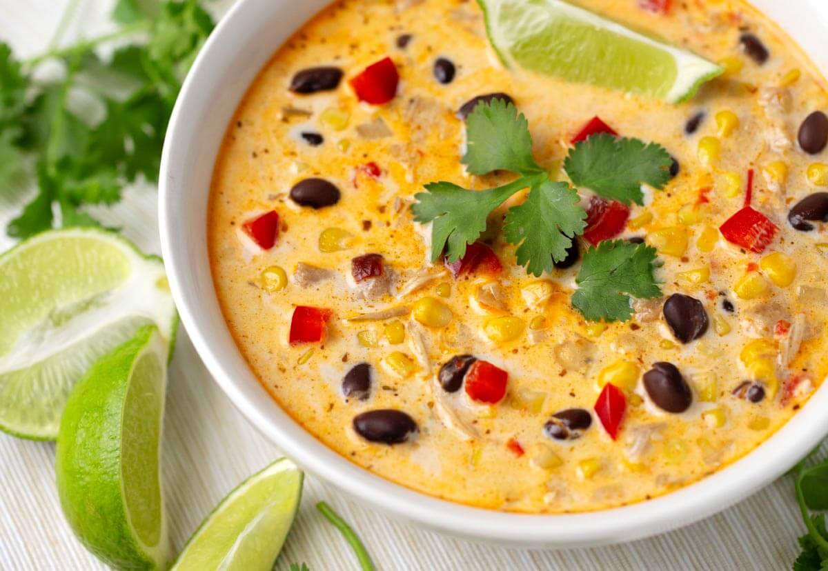 Mexican corn soup in a white bowl closeup.