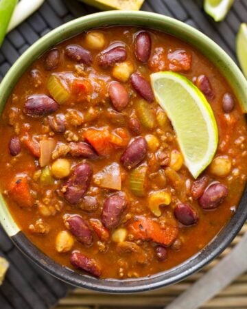 Instant Pot Chili in a bowl with lime wedge.