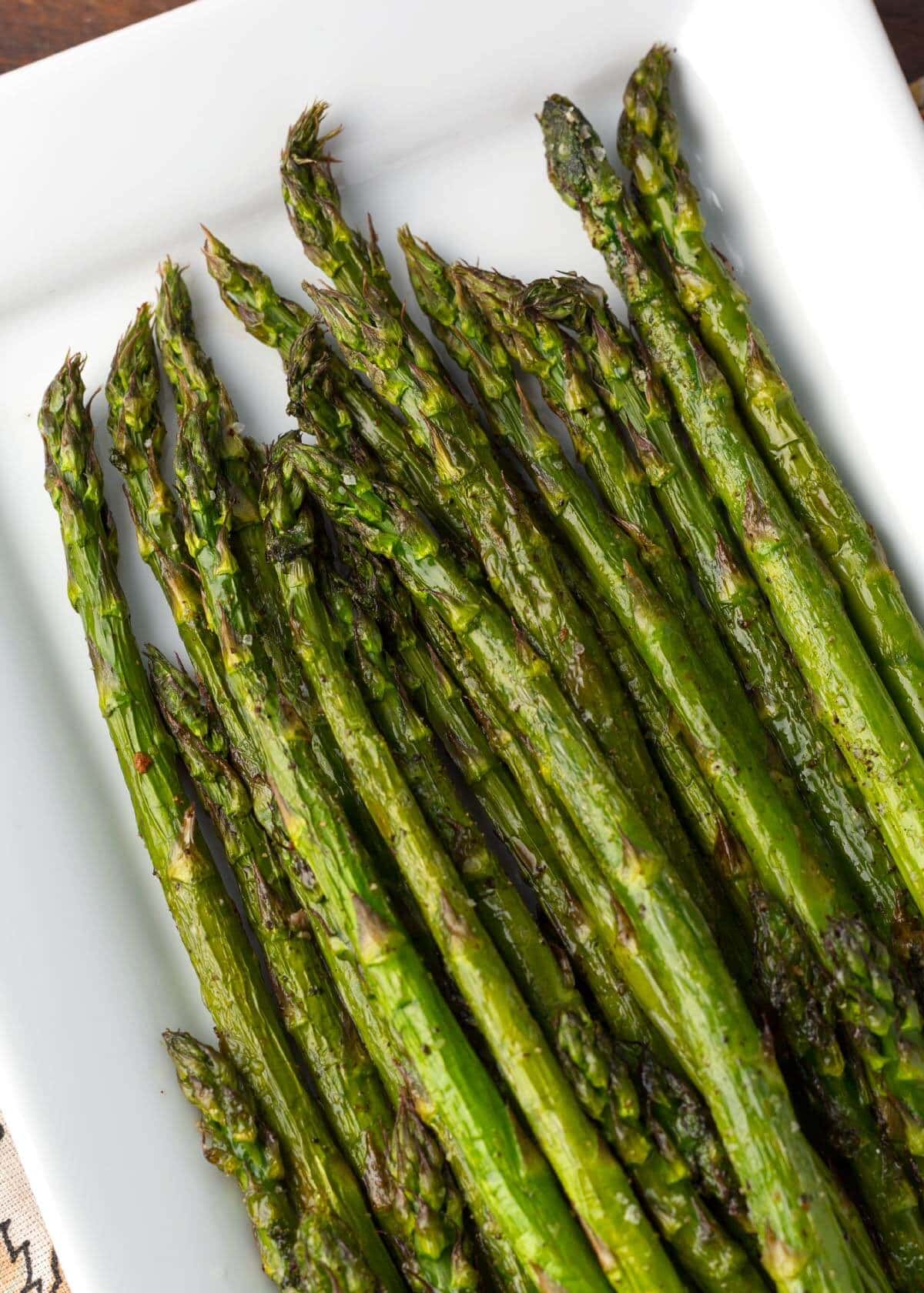 Air Fryer Asparagus spears on a white plate