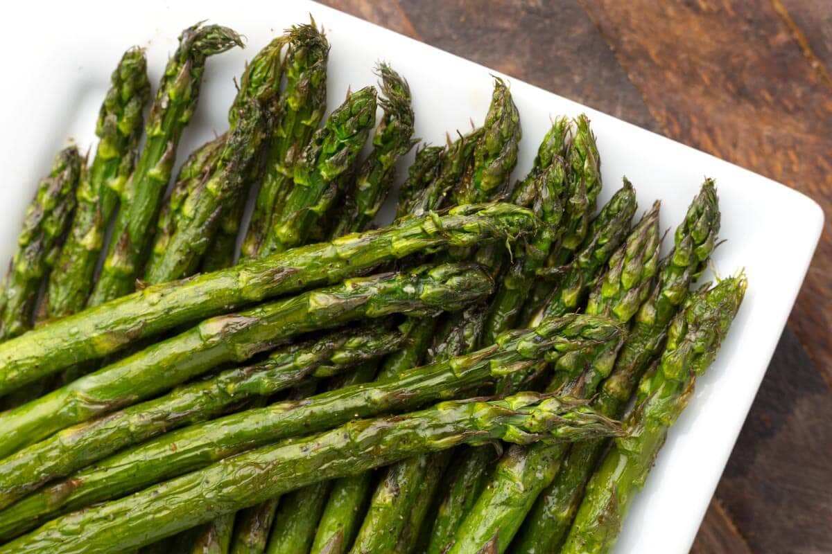 Air Fryer Asparagus spears on a white plate