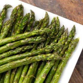 Air Fryer Asparagus spears on a white plate