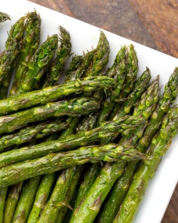 Air Fryer Asparagus spears on a white plate