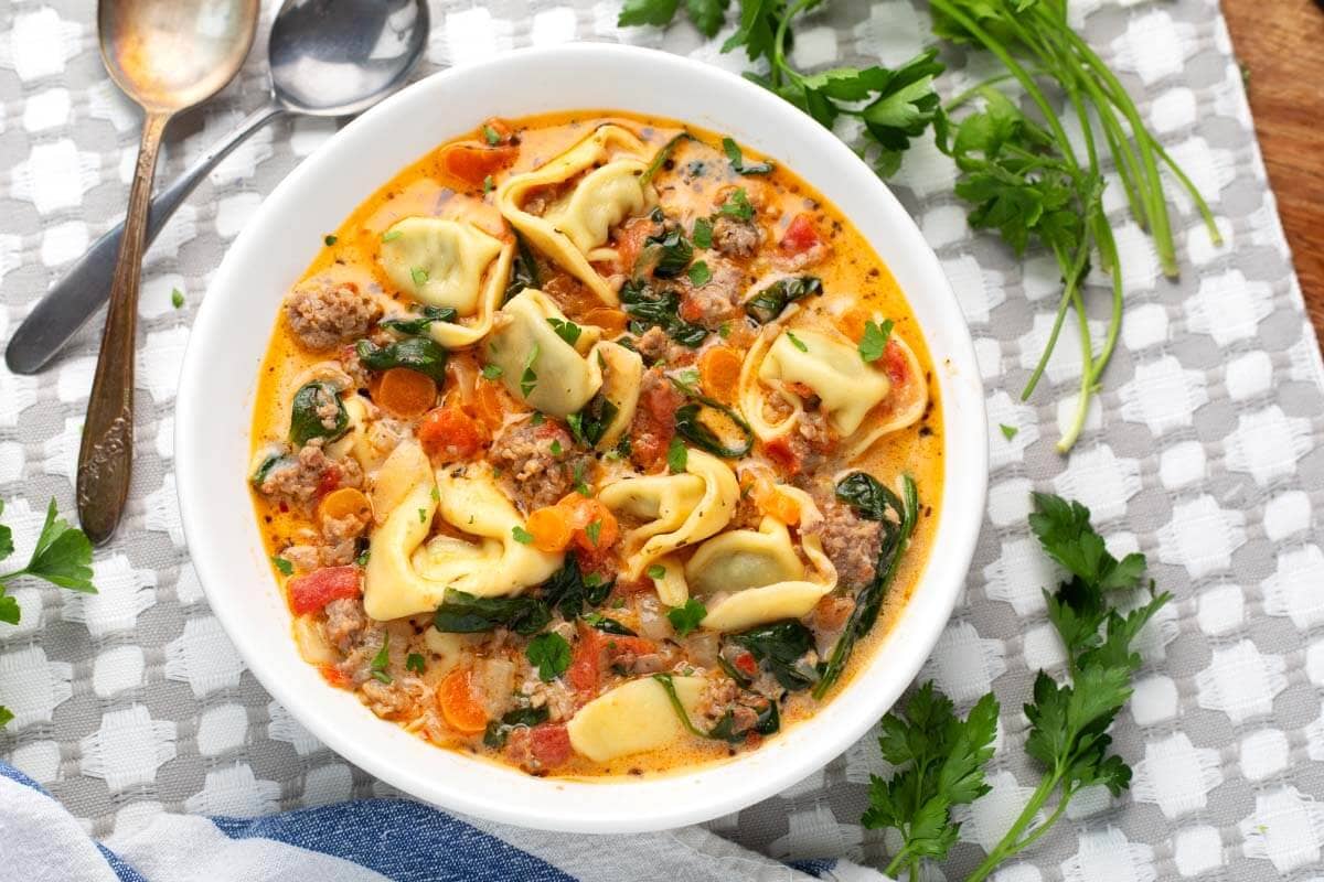 Creamy Tortellini Soup in a white bowl