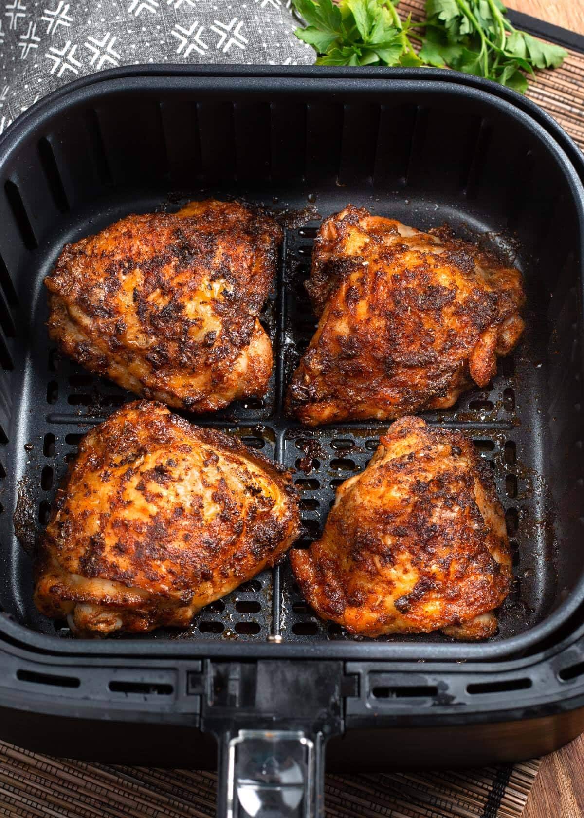 Air Fryer Chicken Thighs in air fryer basket