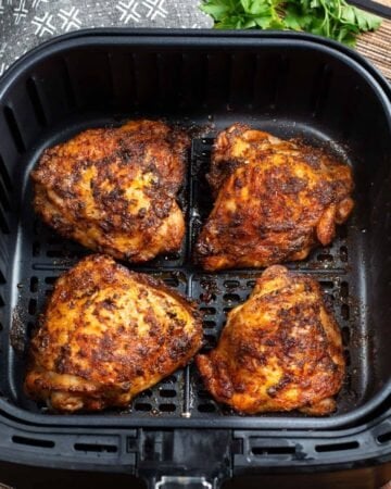 Air Fryer Chicken Thighs in air fryer basket