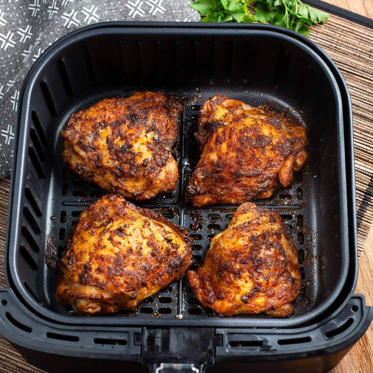 Air Fryer Chicken Thighs in air fryer basket