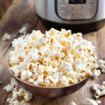 Instant Pot Popcorn in wood bowl in front of IP