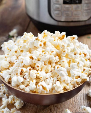 Instant Pot Popcorn in wood bowl in front of IP