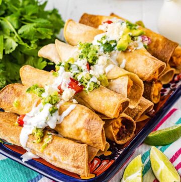 Air Fryer Chicken Taquitos in a stack on platter