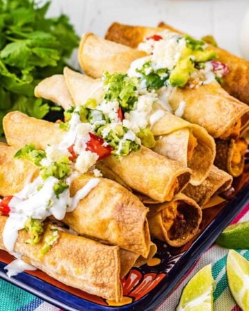 Air Fryer Chicken Taquitos in a stack on platter